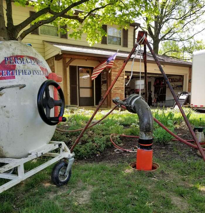 CME Pipe Lining - Trenchless Sewer Reapir image of residential sewer repair in a homeowner's front yard.