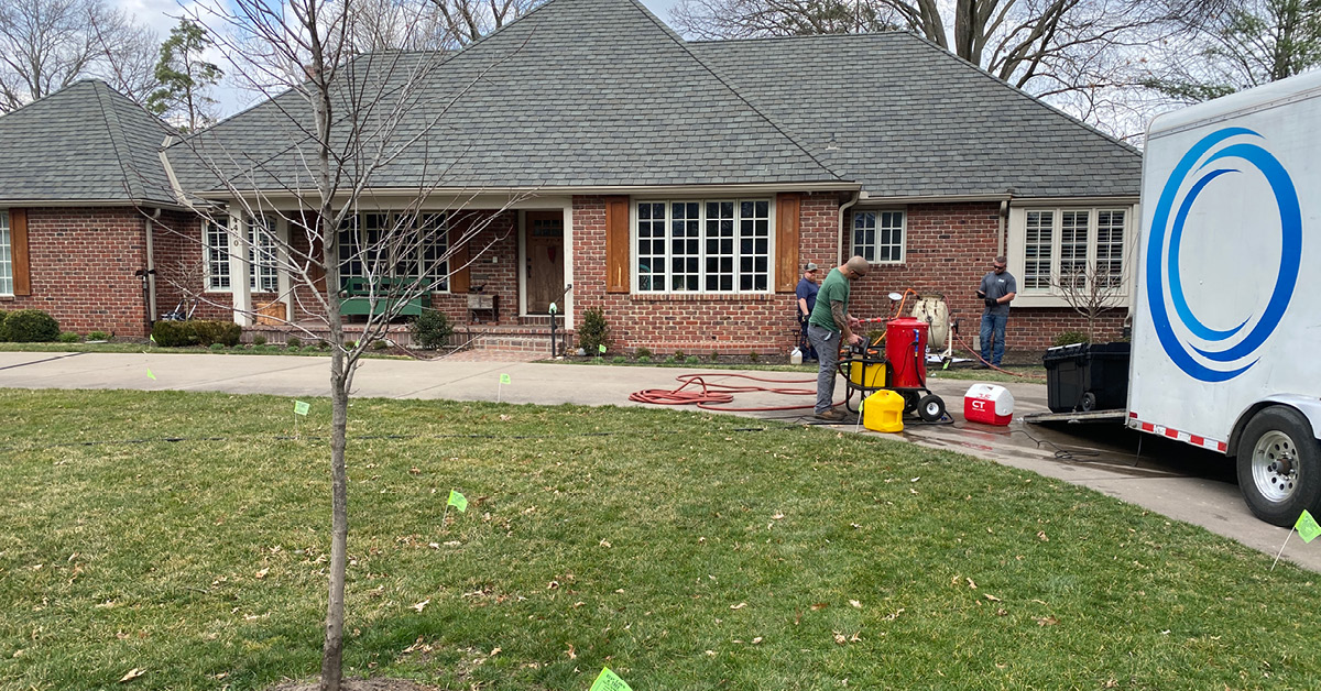 cme sewer repair technicians setting up in the front of a home.
