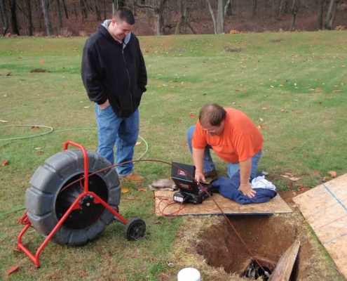 cme sewer repair technicians performing a sewer camera inspection.