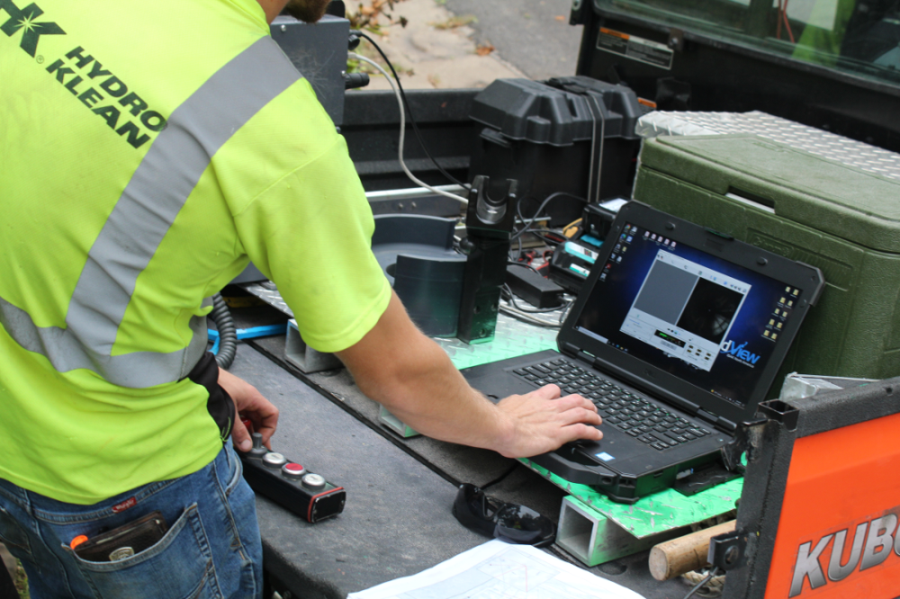 HK technician analyzing I&I data image of man analyzing inflow and infiltration data.