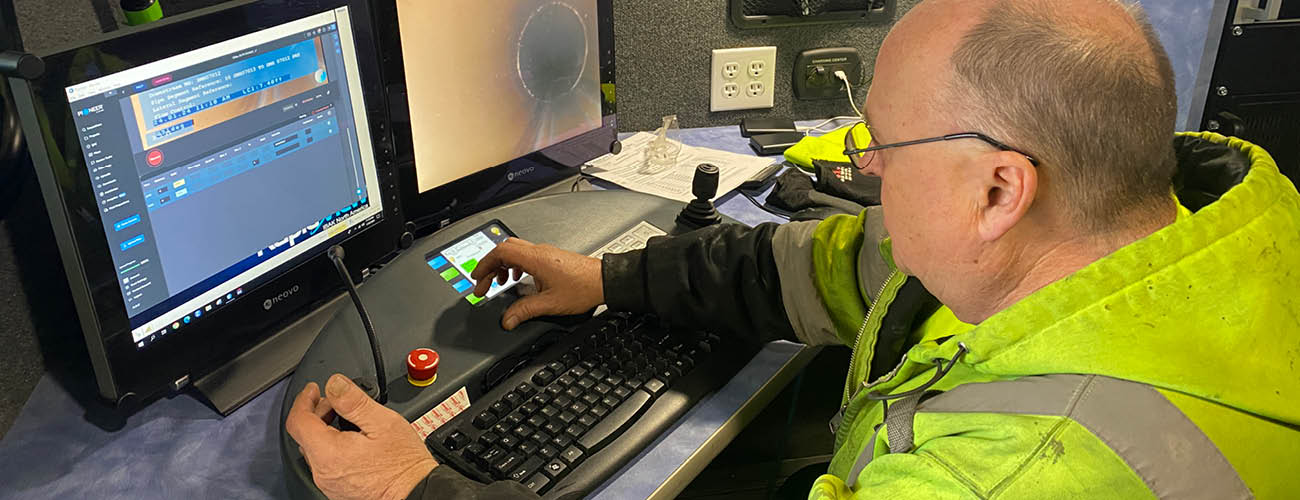 cctv sewer inspection technician reviewing inspection footage.