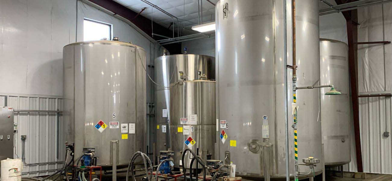 HK Solutions Group Tank Inspection industrial tanks in a facility.