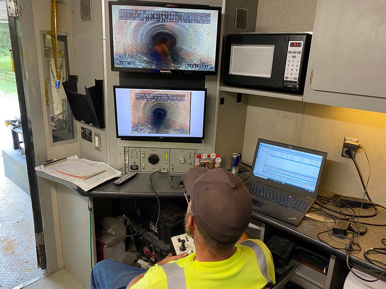 hk team member reviewing sewer inspection footage.