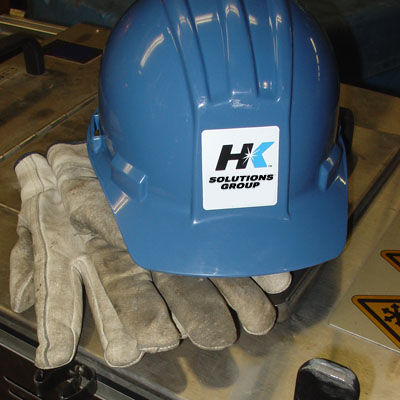 HK Solutions Group hard hat and gloves.