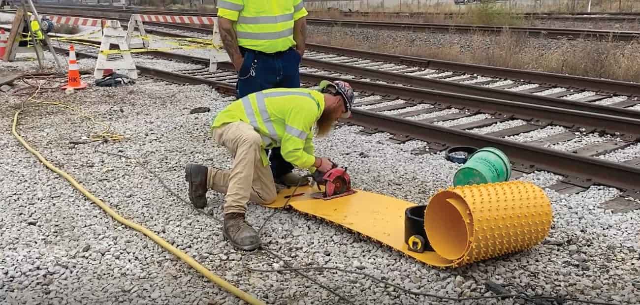 HK Solutions Group employee cutting agru liner for manhole rehabilitation.