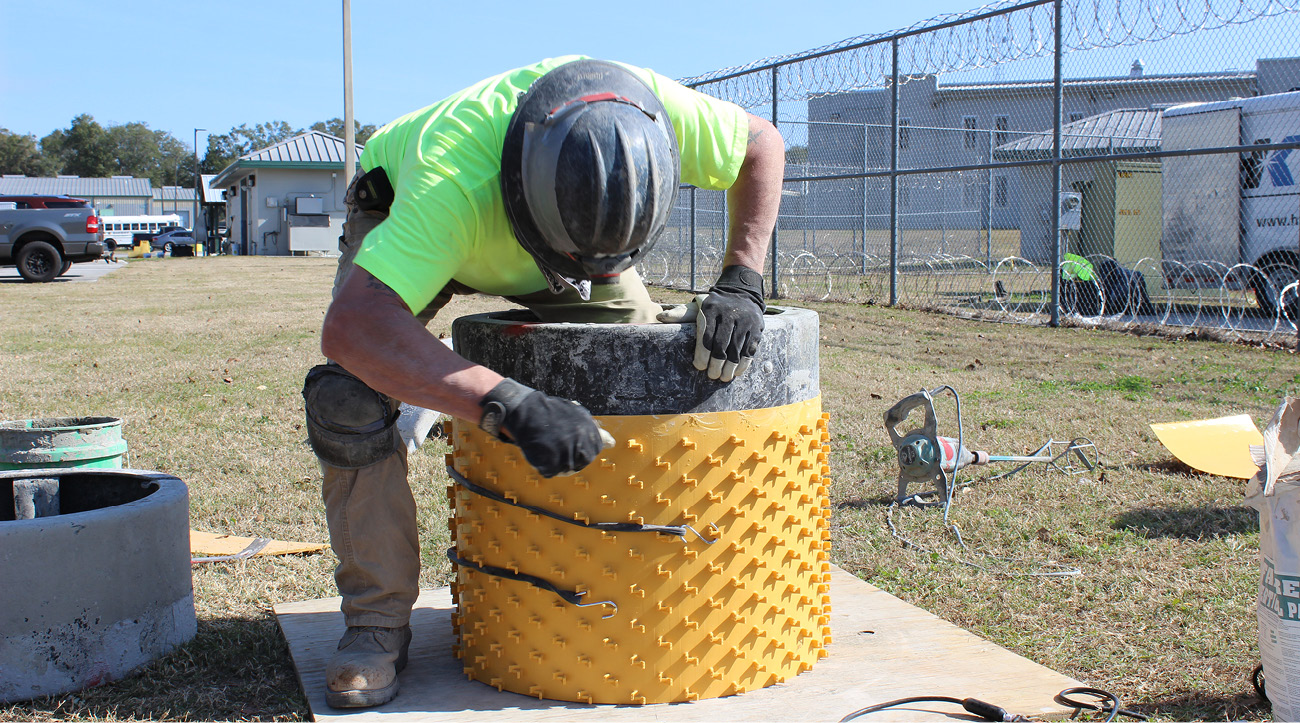 technician applying Monoform™ manhole lining.