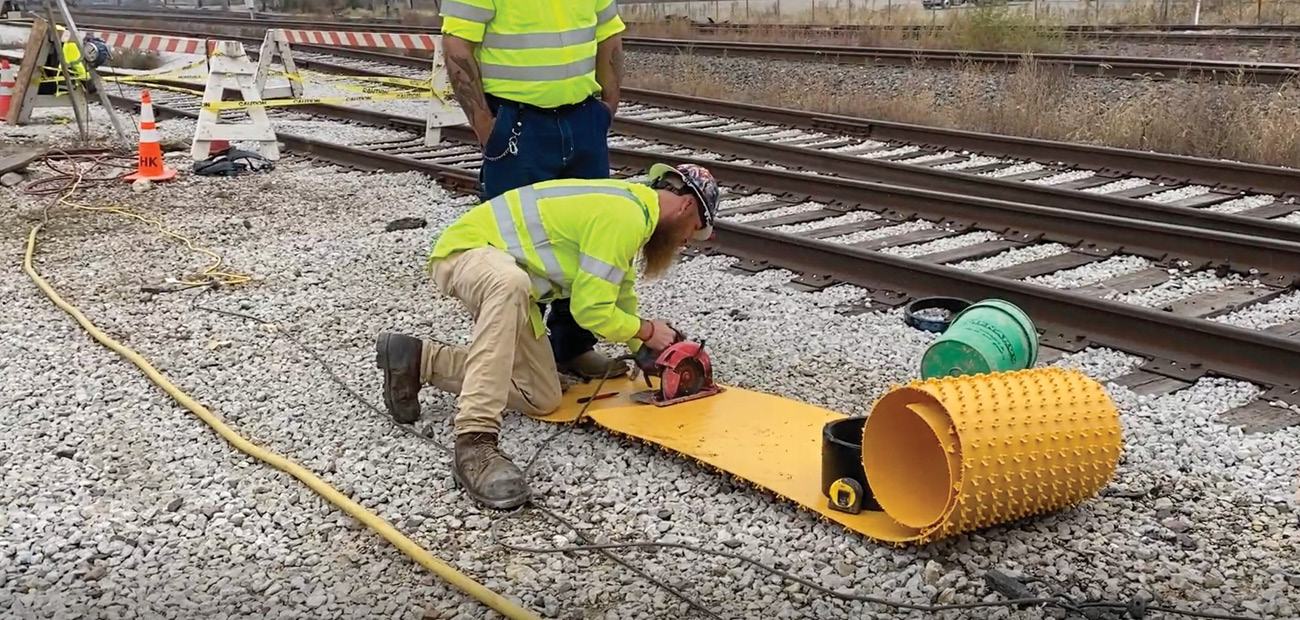 HK Solutions Group Manhole Rehab Services HK Solutions Group employee cutting agru liner for manhole rehabilitation.