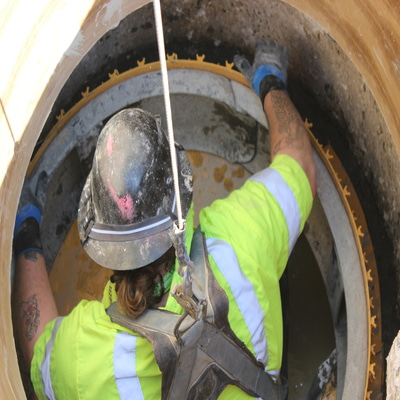 worker repairing a manhole